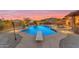 Stunning pool area with diving board, surrounding desert landscape and mountain views at 10931 S Santa Columbia Dr, Goodyear, AZ 85338