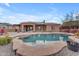 Backyard paradise featuring a large freeform pool, mature landscaping, and a peaceful ambiance at 10931 S Santa Columbia Dr, Goodyear, AZ 85338
