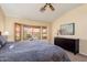 Sun-filled primary bedroom with a charming window seat, plantation shutters, and built-in cabinets at 14108 W Circle Ridge Dr, Sun City West, AZ 85375