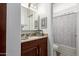 Well-lit bathroom with a vanity, mirror, and a separate toilet and shower area at 14145 N 92Nd St # 1031, Scottsdale, AZ 85260
