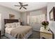 Bright bedroom featuring a cozy bed with decorative pillows, a ceiling fan, and ample natural light at 14145 N 92Nd St # 1031, Scottsdale, AZ 85260