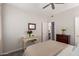 Cozy bedroom with a comfortable bed, dresser with flowers, and connecting bathroom at 14145 N 92Nd St # 1031, Scottsdale, AZ 85260