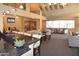 Open-concept clubhouse with bar seating, TV, and multiple seating areas for residents to enjoy at 14145 N 92Nd St # 1031, Scottsdale, AZ 85260