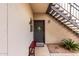 Cozy entry featuring a gray front door, a bench, exterior stairs, and decorative landscaping at 14145 N 92Nd St # 1031, Scottsdale, AZ 85260