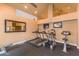 Well-equipped home gym with treadmills, elliptical, exercise bike, and TVs for a complete workout experience at 14145 N 92Nd St # 1031, Scottsdale, AZ 85260