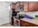 Well-equipped kitchen with stainless steel appliances, dark wood cabinetry, and granite countertops at 14145 N 92Nd St # 1031, Scottsdale, AZ 85260