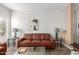 Spacious living room featuring a plush brown sofa, lamps, stylish tables, and modern decor at 14145 N 92Nd St # 1031, Scottsdale, AZ 85260