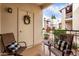 Inviting outdoor patio area with seating and a decorative wreath, offering a relaxing space at 14145 N 92Nd St # 1031, Scottsdale, AZ 85260