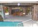 Outdoor pool features lounge area with stone columns and covered dining table for poolside enjoyment at 14145 N 92Nd St # 1031, Scottsdale, AZ 85260