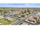 Expansive aerial view of a well-maintained neighborhood with mature landscaping and solar panels, under a clear blue sky at 14633 N Boswell Blvd, Sun City, AZ 85351