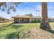 Wide view of the green backyard with a covered patio, showcasing its expansive and inviting outdoor space at 14633 N Boswell Blvd, Sun City, AZ 85351