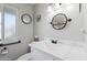 Clean bathroom featuring modern vanity, decorative mirror, and natural light at 14633 N Boswell Blvd, Sun City, AZ 85351