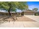 Charming single-story home featuring a well-kept yard, mature trees, and a two-car garage at 14633 N Boswell Blvd, Sun City, AZ 85351
