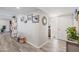 Bright hallway with wood-look floors, decorated with art and an access door at 14633 N Boswell Blvd, Sun City, AZ 85351