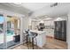 Updated kitchen featuring white cabinets, breakfast bar with seating, and stainless steel appliances at 14633 N Boswell Blvd, Sun City, AZ 85351