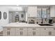 Modern kitchen with white cabinets, stylish backsplash, breakfast bar and eat in kitchen at 14633 N Boswell Blvd, Sun City, AZ 85351