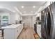 Open-concept kitchen featuring white cabinets, stainless appliances and updated lighting at 14633 N Boswell Blvd, Sun City, AZ 85351