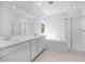 Modern bathroom featuring double sinks, a soaking tub, and a separate glass-enclosed shower at 14777 W Soft Wind Dr, Surprise, AZ 85387