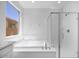 Bright bathroom showcasing a luxurious soaking tub and a modern glass-enclosed shower at 14777 W Soft Wind Dr, Surprise, AZ 85387