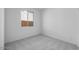 Neutral carpeted bedroom with white walls and a window at 14777 W Soft Wind Dr, Surprise, AZ 85387