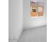 Bright bedroom with white walls and neutral carpeting and a window at 14777 W Soft Wind Dr, Surprise, AZ 85387