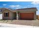 Exterior facade with brick accents, neutral colors, and a brick driveway at 14777 W Soft Wind Dr, Surprise, AZ 85387