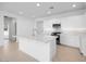 Open-concept kitchen with white cabinets, stainless steel appliances, a large island, and a modern backsplash at 14777 W Soft Wind Dr, Surprise, AZ 85387