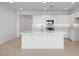 Spacious kitchen with white cabinets, stainless steel appliances, a center island, and modern backsplash at 14777 W Soft Wind Dr, Surprise, AZ 85387