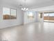Bright, open-plan living room features tile floors, modern lighting, and large windows at 14777 W Soft Wind Dr, Surprise, AZ 85387