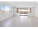 Spacious, light-filled living room with tile flooring, large windows and seamless outdoor access at 14777 W Soft Wind Dr, Surprise, AZ 85387