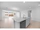 Open-concept living space showcasing a kitchen with a center island and a seamless transition to a bright living room at 14777 W Soft Wind Dr, Surprise, AZ 85387