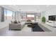 Modern living room boasts a comfortable sectional sofa, stylish rug, and plenty of natural light at 14777 W Soft Wind Dr, Surprise, AZ 85387