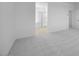 Clean, carpeted bedroom with a view into the ensuite, providing a relaxing and airy feel at 14777 W Soft Wind Dr, Surprise, AZ 85387