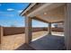 A covered patio is featured with neutral colors and natural lighting at 14777 W Soft Wind Dr, Surprise, AZ 85387