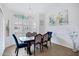 Bright dining room with elegant chandelier, stylish decor, and comfortable seating at 1589 E Manor Dr, Casa Grande, AZ 85122