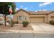 Charming single-story home featuring a two-car garage, low maintenance landscaping, and neutral color palette at 1589 E Manor Dr, Casa Grande, AZ 85122
