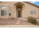 Inviting front entrance features a decorative security door, beautiful landscaping, and stepping stone walkway at 1589 E Manor Dr, Casa Grande, AZ 85122