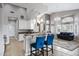 Open concept kitchen features a breakfast bar, modern lighting, and seamless flow to the living area at 1589 E Manor Dr, Casa Grande, AZ 85122