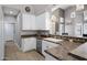 Well-lit kitchen with white cabinetry, stainless steel appliances, and ample countertop space at 1589 E Manor Dr, Casa Grande, AZ 85122