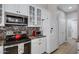 Well-equipped kitchen featuring modern appliances, white cabinetry, and tile backsplash at 1589 E Manor Dr, Casa Grande, AZ 85122
