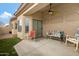 Cozy covered patio with a ceiling fan, colorful seating, and sliding glass doors for indoor-outdoor living at 1589 E Manor Dr, Casa Grande, AZ 85122