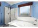 Bathroom featuring soaking tub, shower, and privacy window at 15911 W Carmen Dr, Surprise, AZ 85374