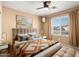 Sunlit bedroom offering neutral tones, complemented by a large window with neighborhood views at 15911 W Carmen Dr, Surprise, AZ 85374
