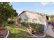 Charming single-story home with a well-manicured lawn and lush landscaping at 15911 W Carmen Dr, Surprise, AZ 85374