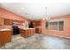 Well-lit kitchen with an island, tiled floor and a window bringing in natural light at 15911 W Carmen Dr, Surprise, AZ 85374