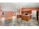 Open-concept kitchen with island, stainless steel appliances, and adjacent living area at 15911 W Carmen Dr, Surprise, AZ 85374