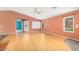 Open-concept living room with wood floors, a ceiling fan, and bright natural light at 15911 W Carmen Dr, Surprise, AZ 85374