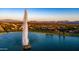 Stunning aerial view of community lake featuring a water fountain and mountain views at 16545 E Gunsight Dr # 103, Fountain Hills, AZ 85268