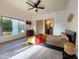 Bright bedroom features a large window overlooking a pool, a king-size bed, and modern decor at 16545 E Gunsight Dr # 103, Fountain Hills, AZ 85268