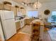 Bright kitchen with island, tile backsplash, ample cabinet space, and modern appliances at 16545 E Gunsight Dr # 103, Fountain Hills, AZ 85268